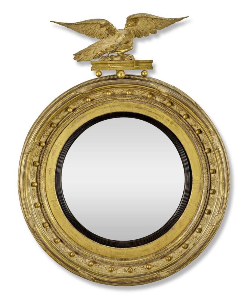 A George IV giltwood and gilt gesso convex mirror, circa 1825, with an associated 19th century eagle.