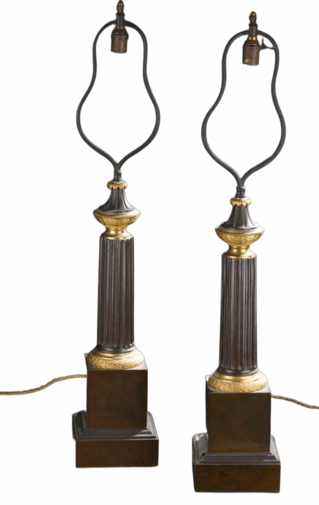 A pair of patinated and gilded bronze lamps, circa 1840.