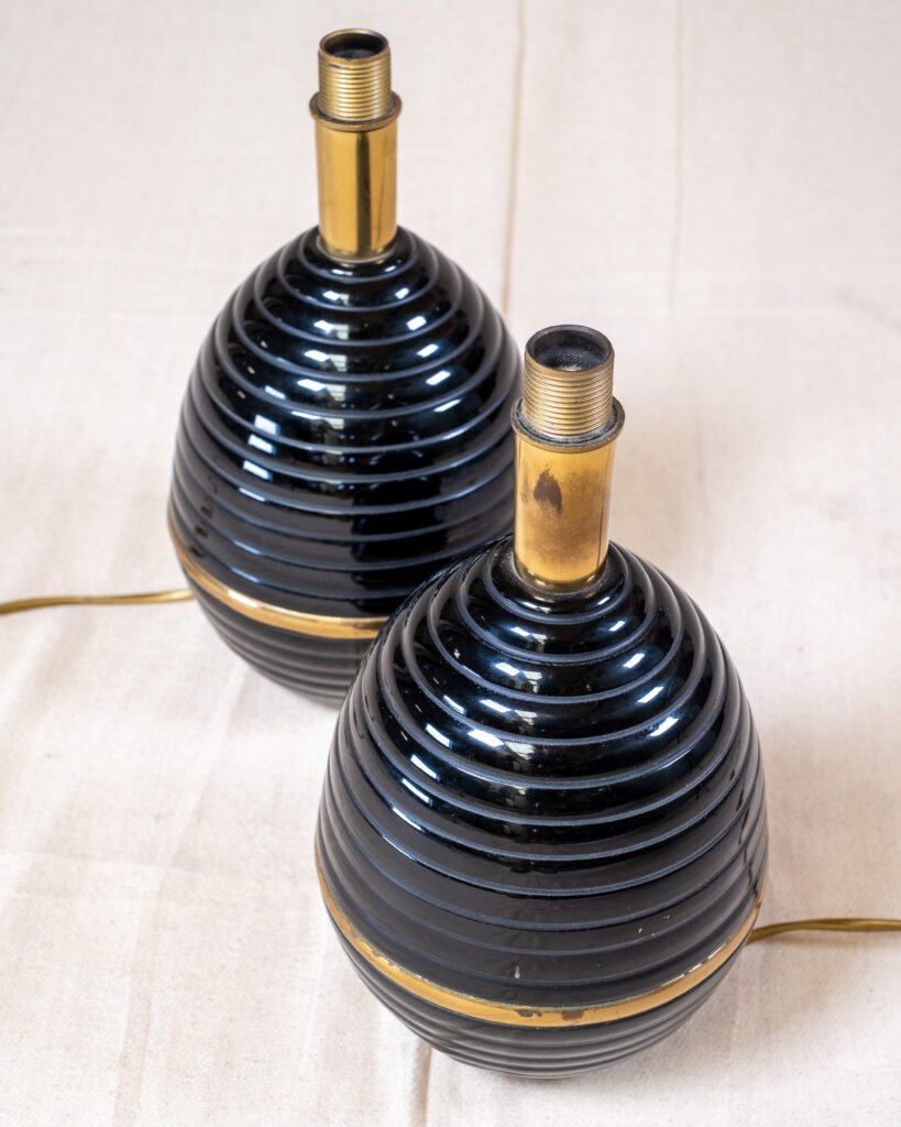 A pair of black ceramic and gilt lamps.