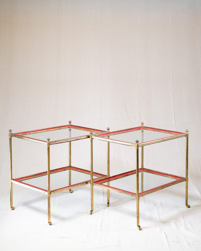 A pair of two tier red lacquer tables, circa 1970s.