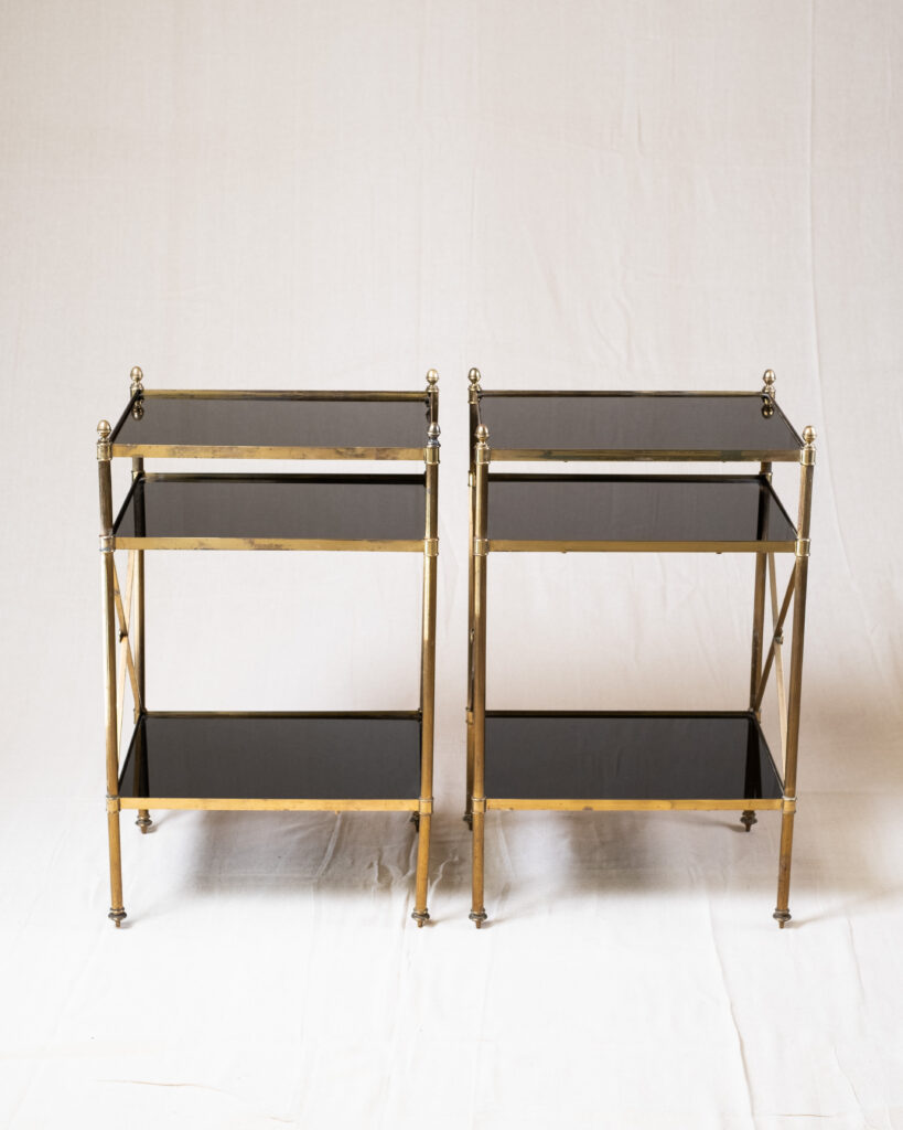 A pair of Maison Bagues, brass and black glass etagere, mid-century.