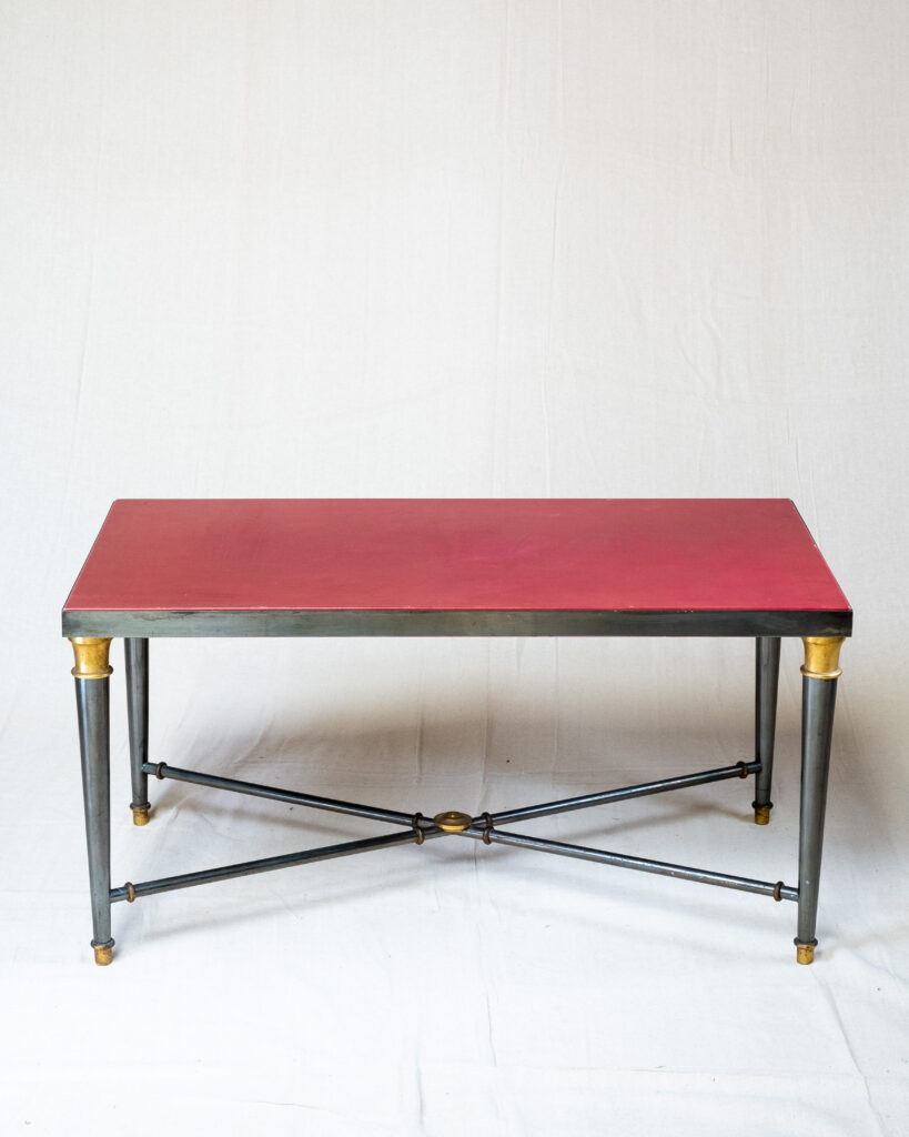 A Maison Jansen coffee table with a red leather top, circa 1970s.