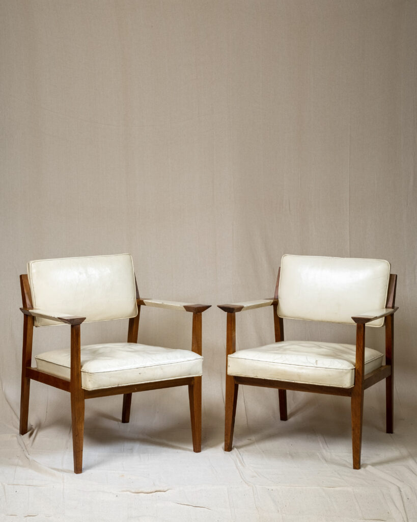 A pair of mid-century armchairs by Giacomo Buzzita .