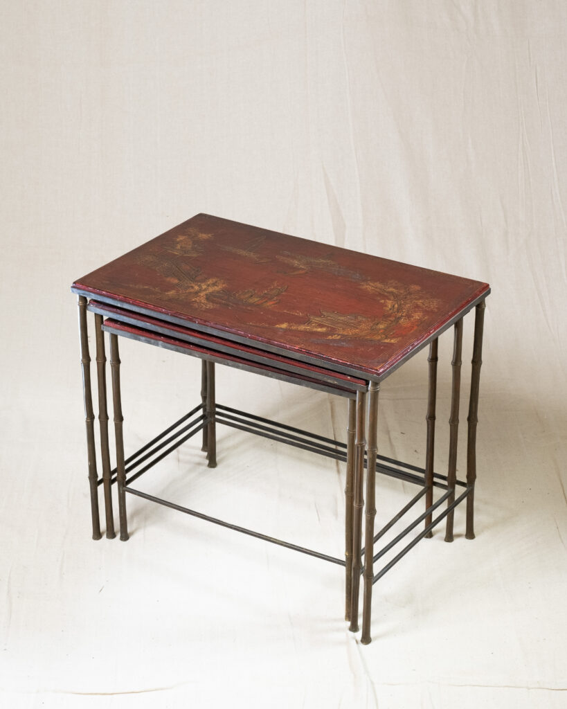 A nest of three red lacquer tables by Maison Bagues.