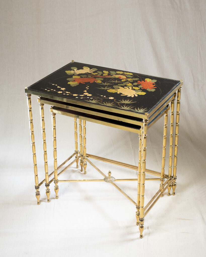 A nest of three mid-century tables by Maison Baguès.