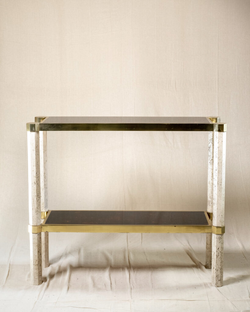 A brass, travertine and faux tortoiseshell console table attributed to Maison Jansen, circa a 1970.