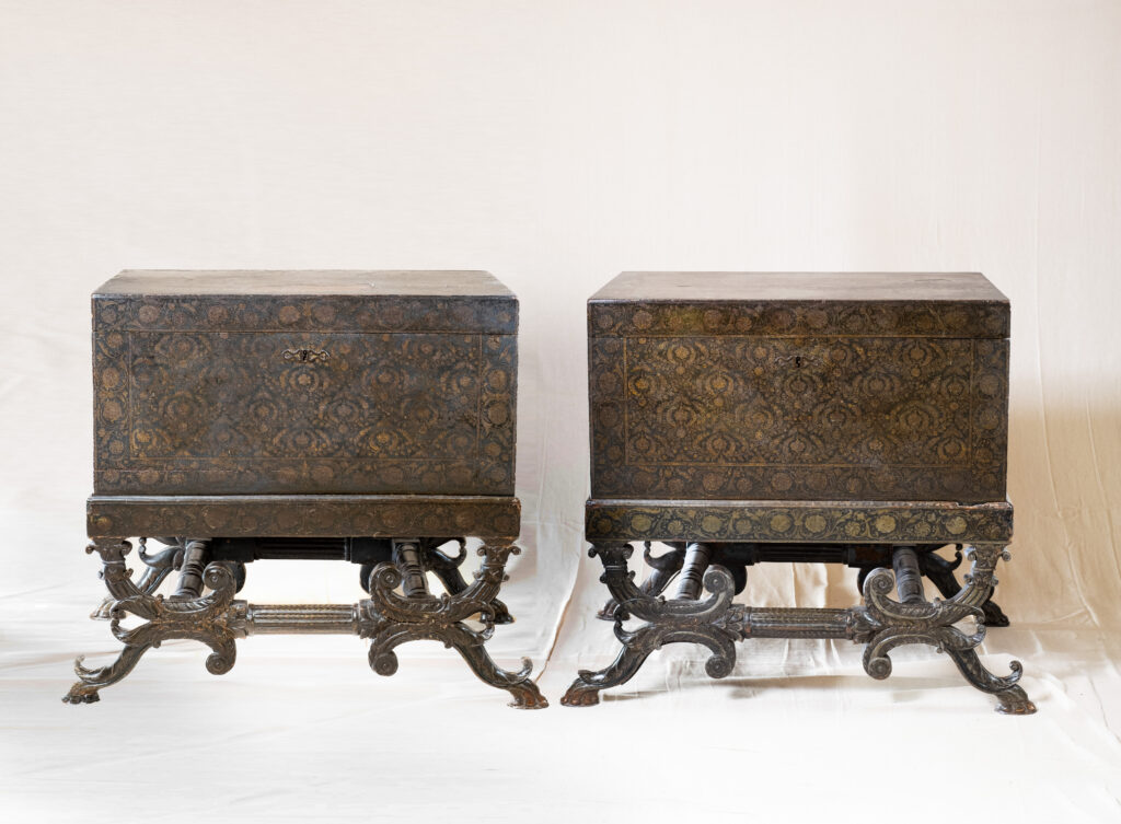 A pair of Anglo-Indian iron-mounted chests, on stands.